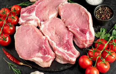 Raw pork steaks with ribs on stone background