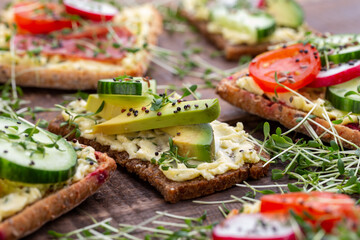 Sandwiches with cream cheese, vegetables and salami.