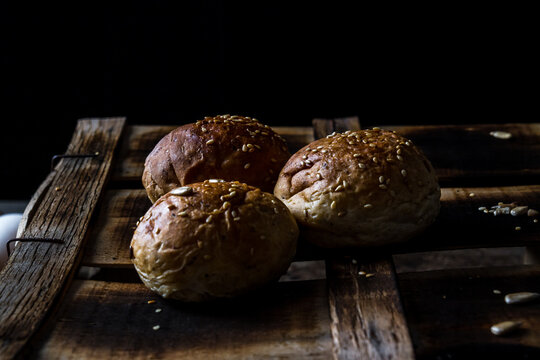 Whole wheat kaiser rolls with sesame seeds on retro crate