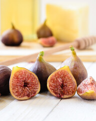 Close-up of figs, honey and cheese. Retro, vintage look. Selective focus