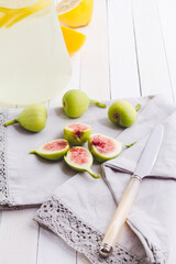 Lemonade and figs on retro wooden table. selective focus. Fall's fruit still life..