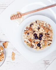 Homemade vegan granola cereal with soy yogurt, walnuts, blueberry and almond milk.