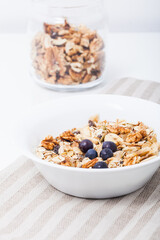 Homemade vegan granola cereal with soy yogurt, walnuts, blueberry and almond milk.