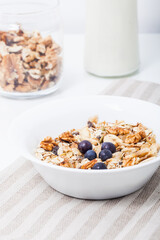 Homemade vegan granola cereal with soy yogurt, walnuts, blueberry and almond milk.
