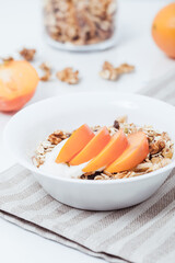 Homemade vegan granola cereal with soy yogurt, walnuts, fuji apple and almond milk.