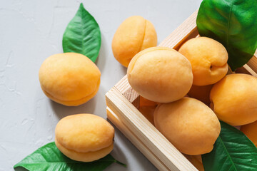 Top-down view of fresh juicy apricots in a wooden box. Selective focus.
