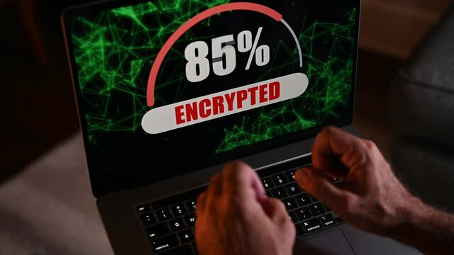 Computer being encrypted by ransomware with shaking angry hands