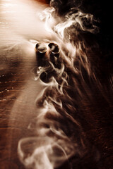 wedding rings in the smoke on a wooden table