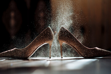 Wedding ring on wedding shoes in splashes of water