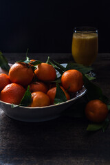 Tangerines in bowl  on the rustic wooden table