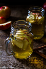 A refreshing jug of apple cider on wood table