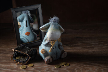 Donkey shaped piggy bank reflected in the mirror, wallet with coins, retirement financial concept.