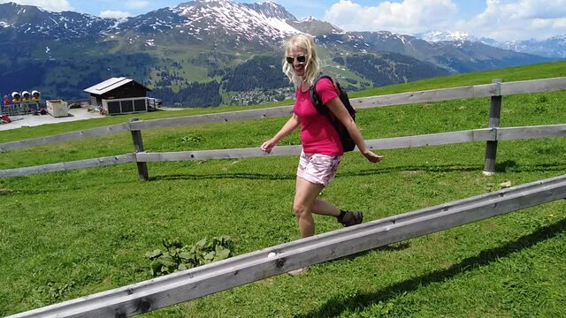 Woman playing marble run game called murmelibahn. In Parpaner Rothorn mount of Switzerland. Swiss cable car station Lenzerheide - Scharmoin of Albula region in Grisons canton. slow motion