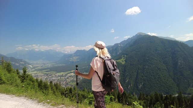 Woman trekking on top of Brambruesch in Switzerland. Swiss tourist resort of Chur or Coira town. Chur skyline in Grisons canton.
