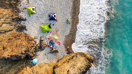 The coast of Cyprus, near the city of Paphos. Top view of the sea, mountains and the beach. Camping, camping with tents in nature.