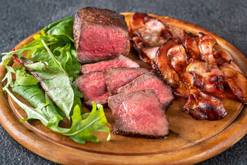 Beef steak with fried bacon