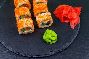 Sushi rolls Philadelphia on a black slate