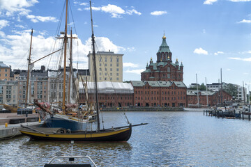 Wooden sailboats moored in old port in Helsinki, Finland. In the background orthodox Uspenski...