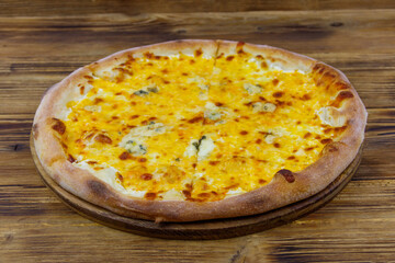 Pizza Four cheese on a wooden background