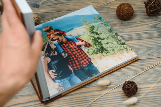 Luxury wooden photo book on natural background. Family memories photobook. Save your summer vacation memories.