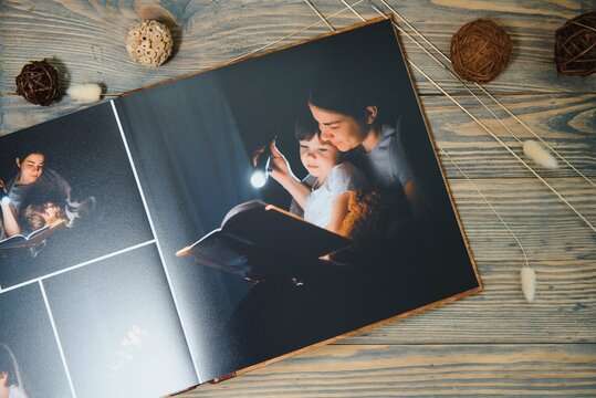 Luxury wooden photo book on natural background. Family memories photobook. Save your summer vacation memories.