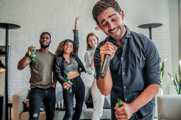Group of friends playing karaoke at home.