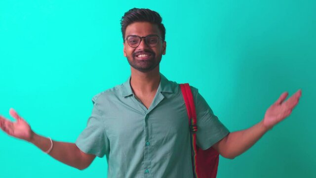 indian student man feeling inspiration idea wear eye glasses holding a pencil in blue studi