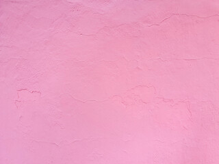 Texture of rough cracked pink stucco texture background. Decorative plaster on the wall.