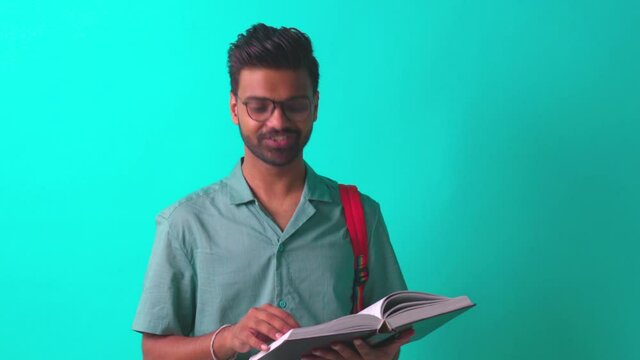 indian student man feeling inspiration idea wear eye glasses holding a pencil in blue studi
