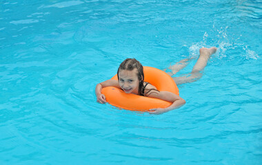Happy child in swimming pool