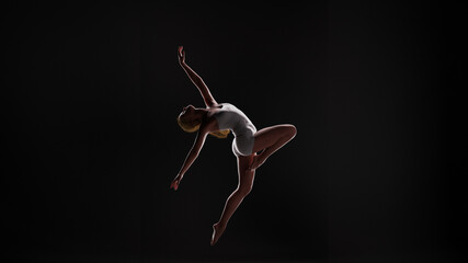 3D illustration of a young female ballet dancer striking a dynamic pose against a dark background with backlighting. - obrazy, fototapety, plakaty