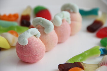 Marshmallow in a glass vase on a white background. Marshmallows in the form of different figures in a vase.Candys