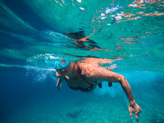 Woman snorkeling in the shallow sea water