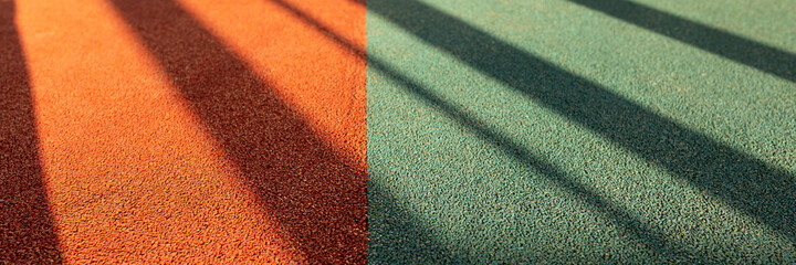 Junction of four multi-colored squares of floor covering with long shadows. Padded floor covering...