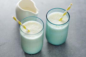 Milkshake in glasses on bright background