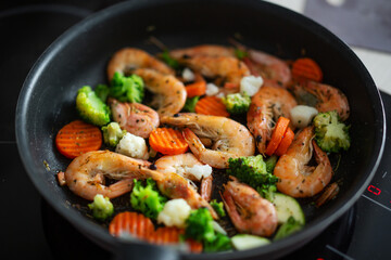 Cooking vegetables and shrimps on pan