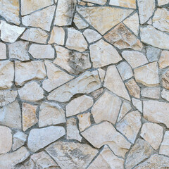 Obraz premium stone wall made of sandstone blocks of different sizes as the background