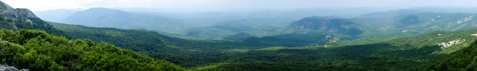 A view of the mountains covered with dense forest from the upper plateau of the Chatyr-Dag mountain range in Crimea. Panorama