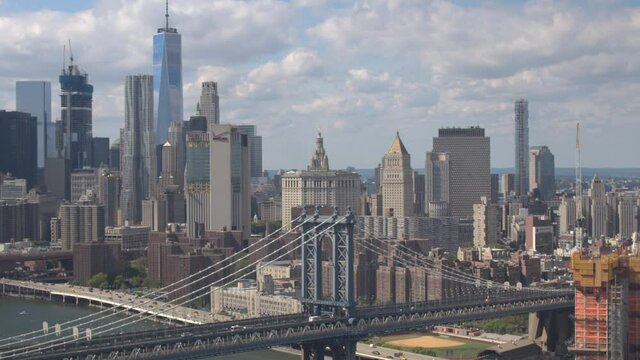 NEW YORK CITY, UNITED STATES OF AMERICA, OCTOBER 2019: AERIAL: Flying over afternoon traffic crossing the famous Manhattan Bridge en route to vibrant New York City. Scenic aerial view of the Big Apple