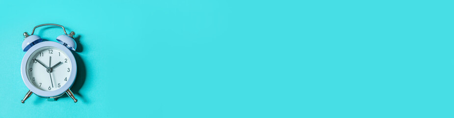 Simply minimal design ringing twin bell vintage classic alarm clock Isolated on blue background....