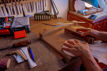 Part of process where luthier is making the body of violin 