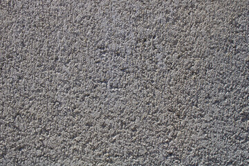 Rough wall with cement and concrete outside.