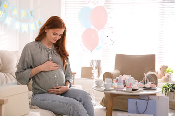 Happy pregnant woman in room decorated for baby shower party - obrazy, fototapety, plakaty