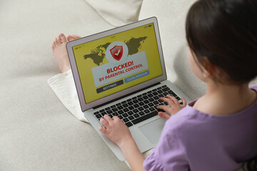 Little girl having access restriction by parental control on laptop. Child safety