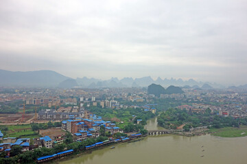 Fototapeta na wymiar Guilin : Beautiful cityscape along the Lijiang river of Guilin city, Guangxi province, China in morning mist. Bird eye view of Guilin city.