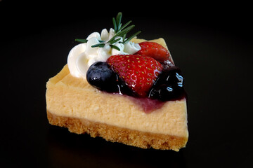 Strawberry and Blueberry French cheese cake. Cheese cake isolated on black background.