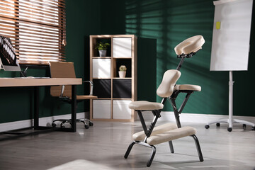 Modern massage chair in office, space for text. Medical equipment
