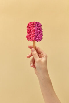 Female hand holding brain ice cream