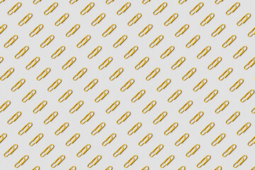 Pattern of yellow paper clips on gray background