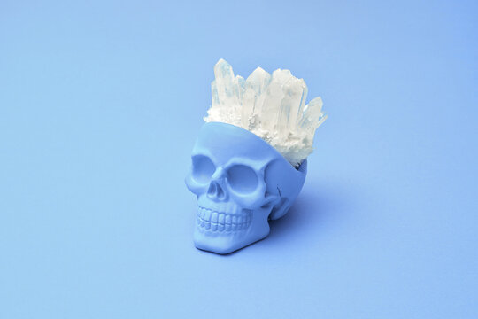 Violet human skull with healing magic quartz crystals